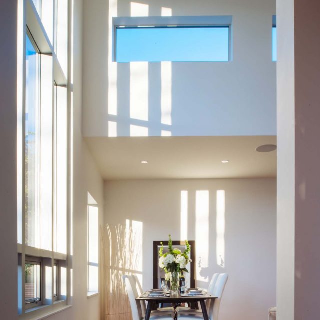 Custom Dining Room Bathed in Sunlight by Kenorah Design + Build