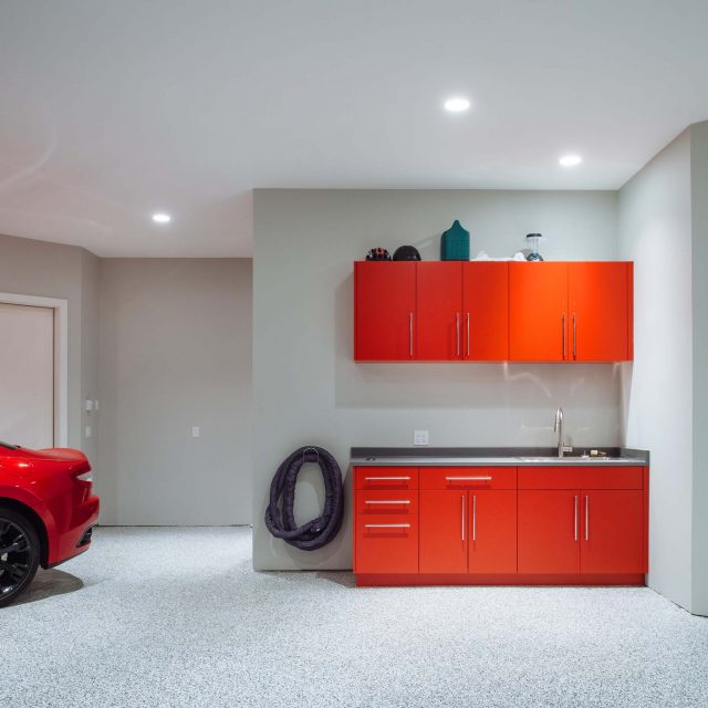 Garage Design with red accents by Kenorah Design + Build