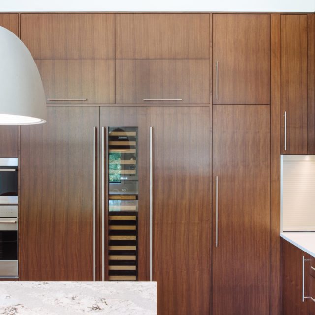 Modern Kitchen with Wood Panelling by Kenorah Design + Build